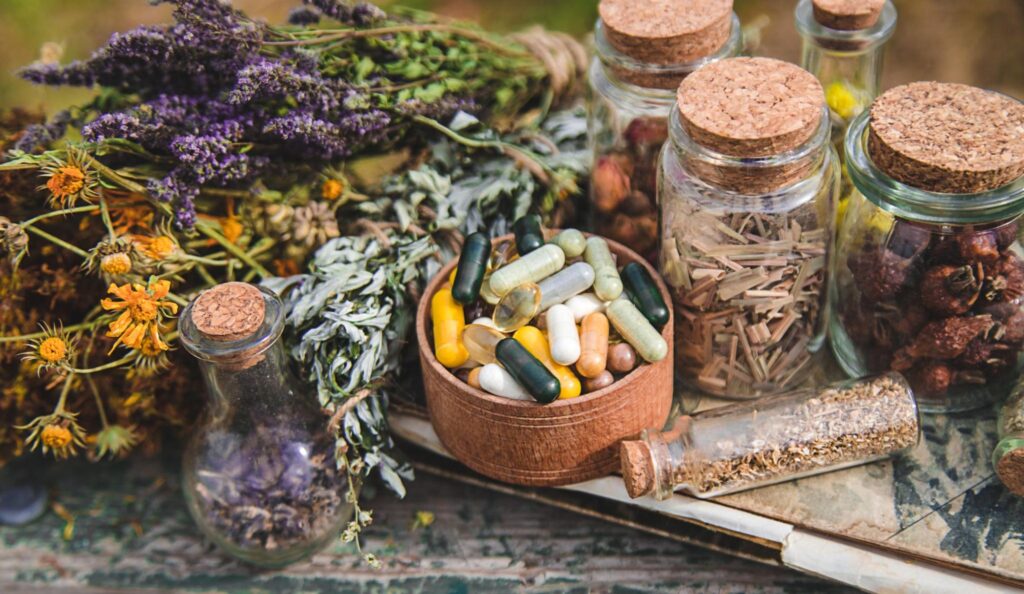 Herbal medicine and tablets on a table.